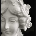 White Marble Bust of Young Woman with Flowers in Hair