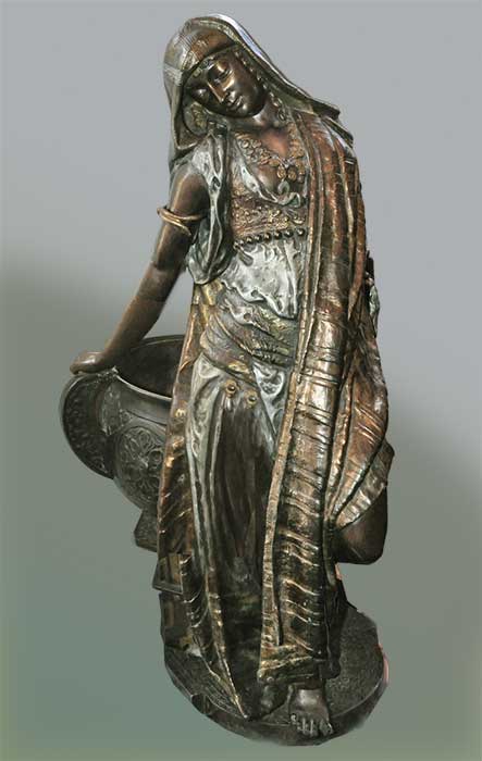 bronze lady sculpture with large urn
