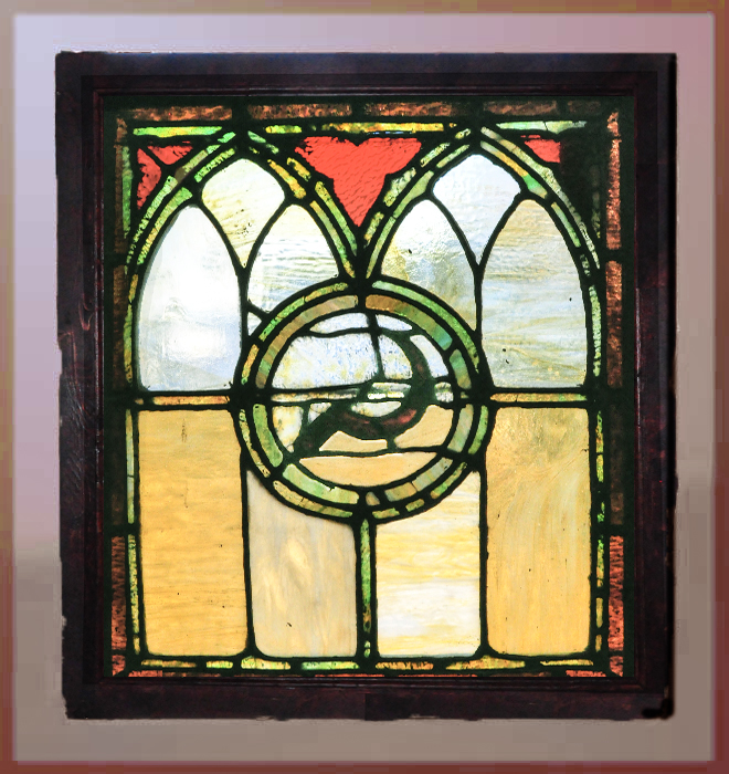 church window with scythe emblem