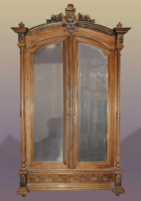 carved walnut armoire with shaped mirrors