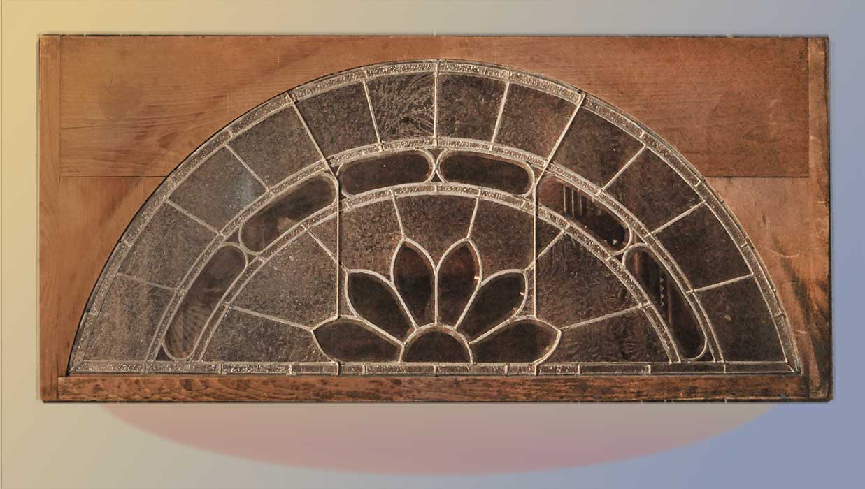 arched window with floral emblem