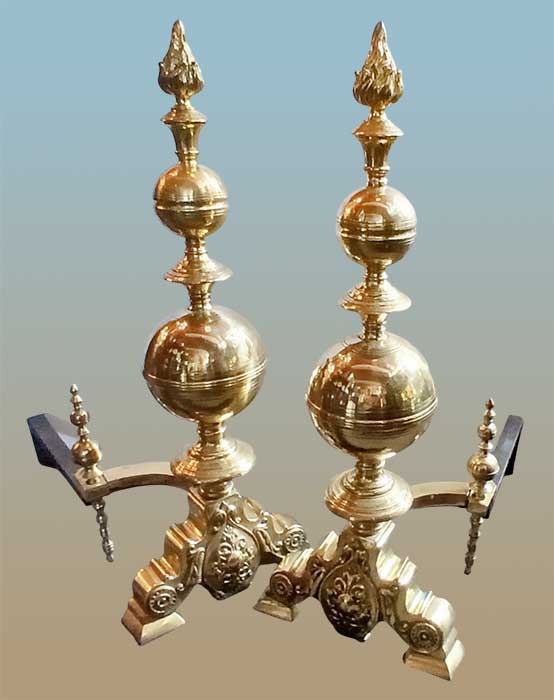 pair of brass andirons with globe-shaped posts